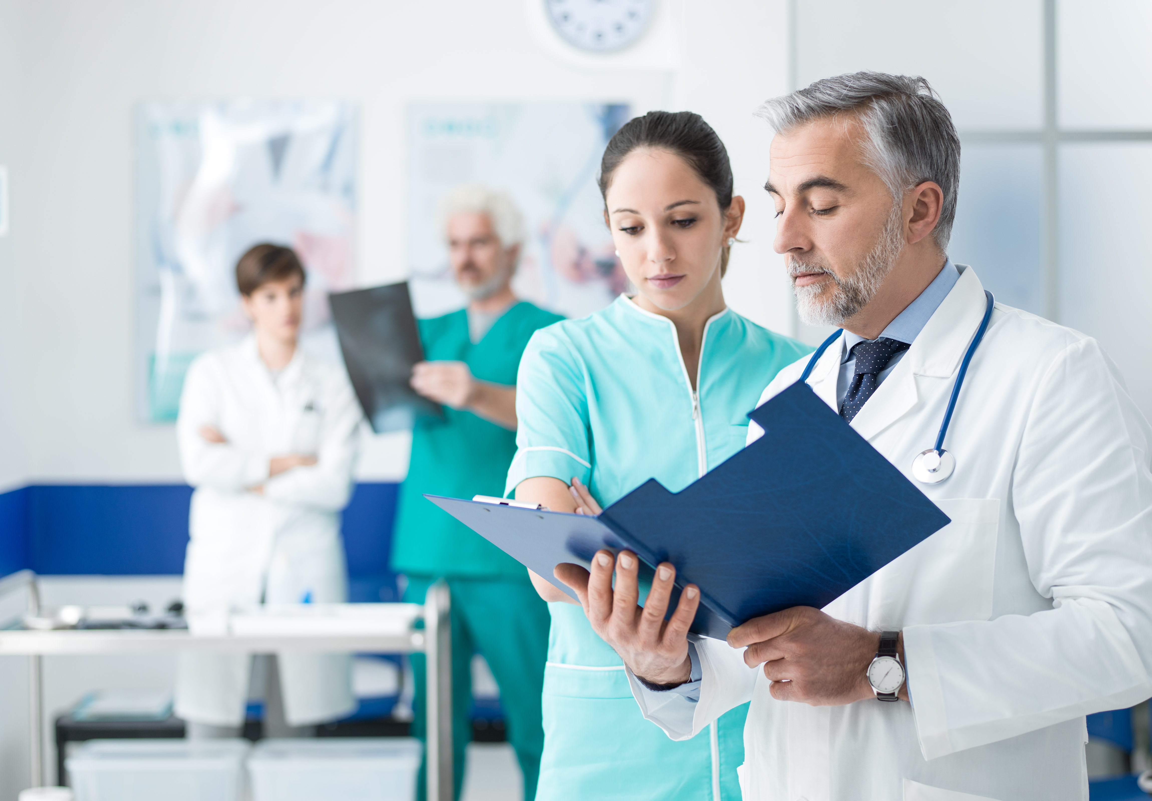 female nurse speaking with male doctor