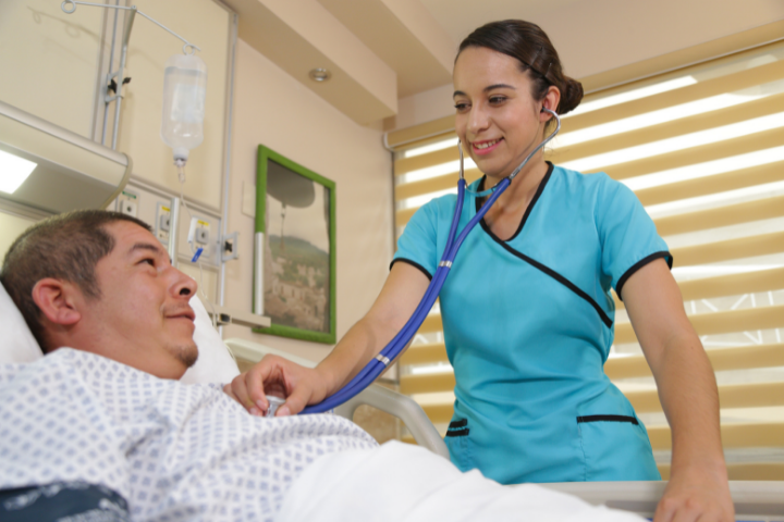 female nurse taking heartbeat of male patient