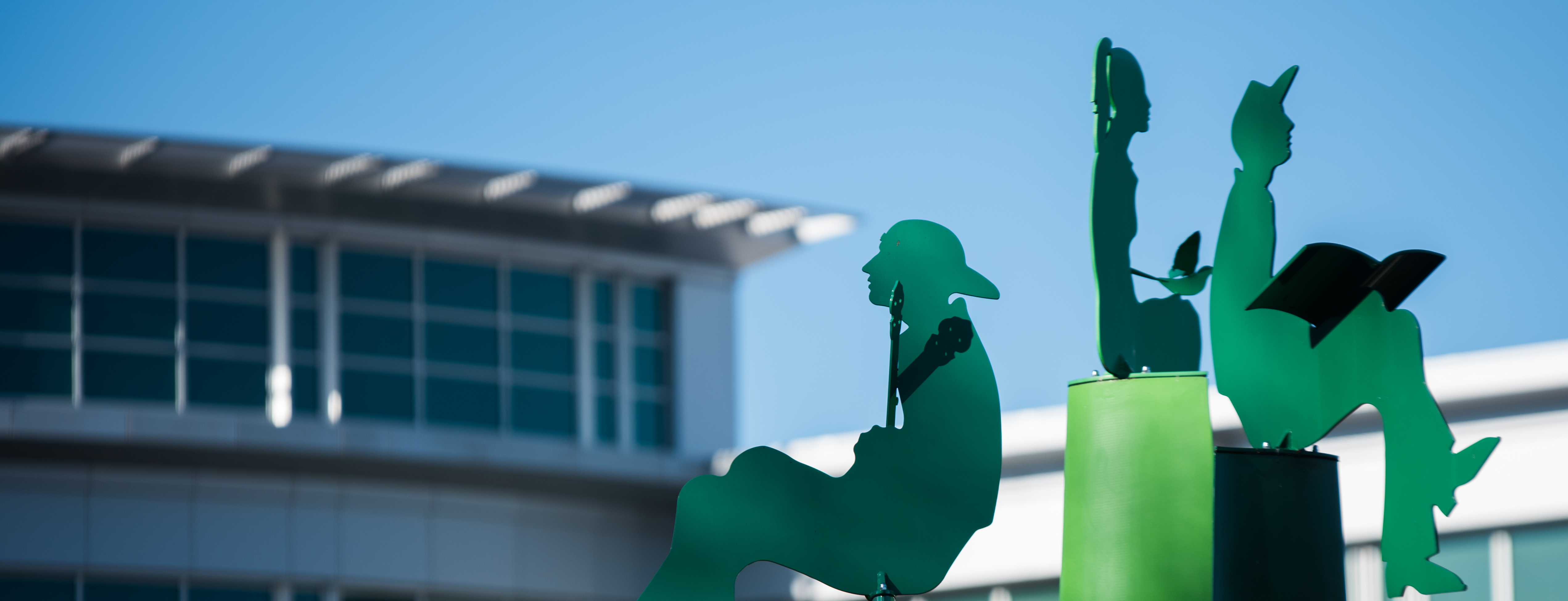 green sculptures and top of library