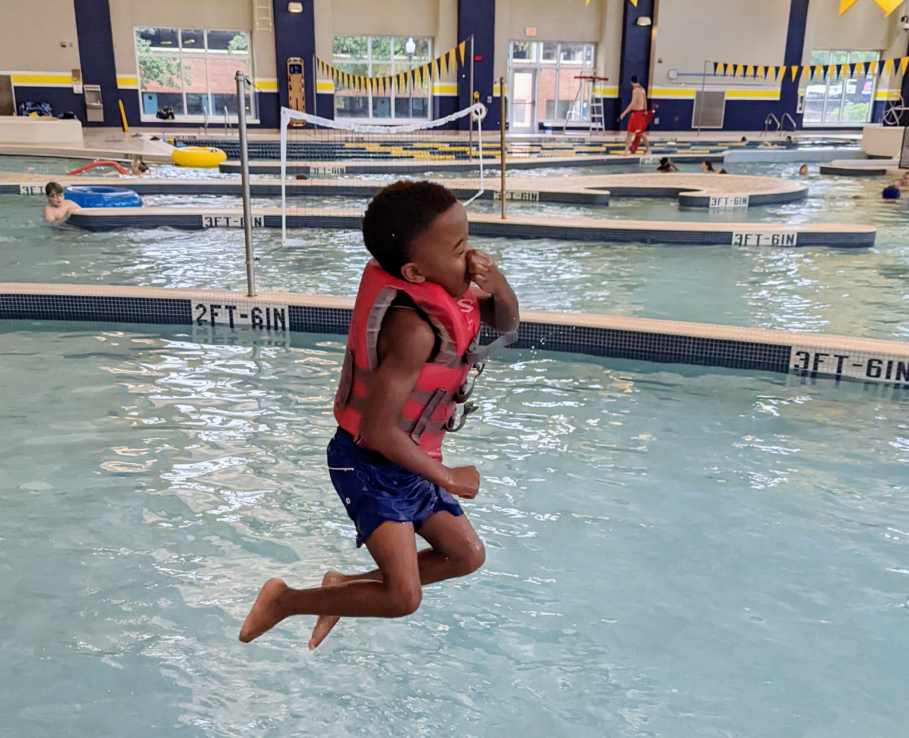 MAC-CamperJumpingPool02 Mocs Adventure Camper jumping into the pool.