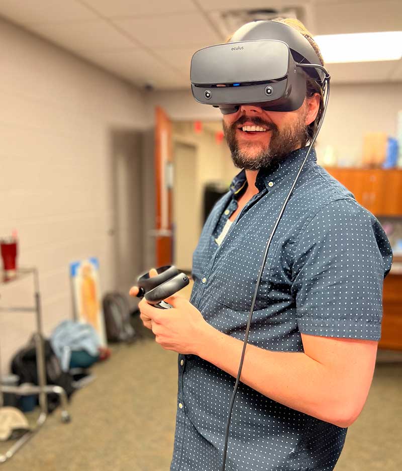 NA student wearing VR headset for simulation