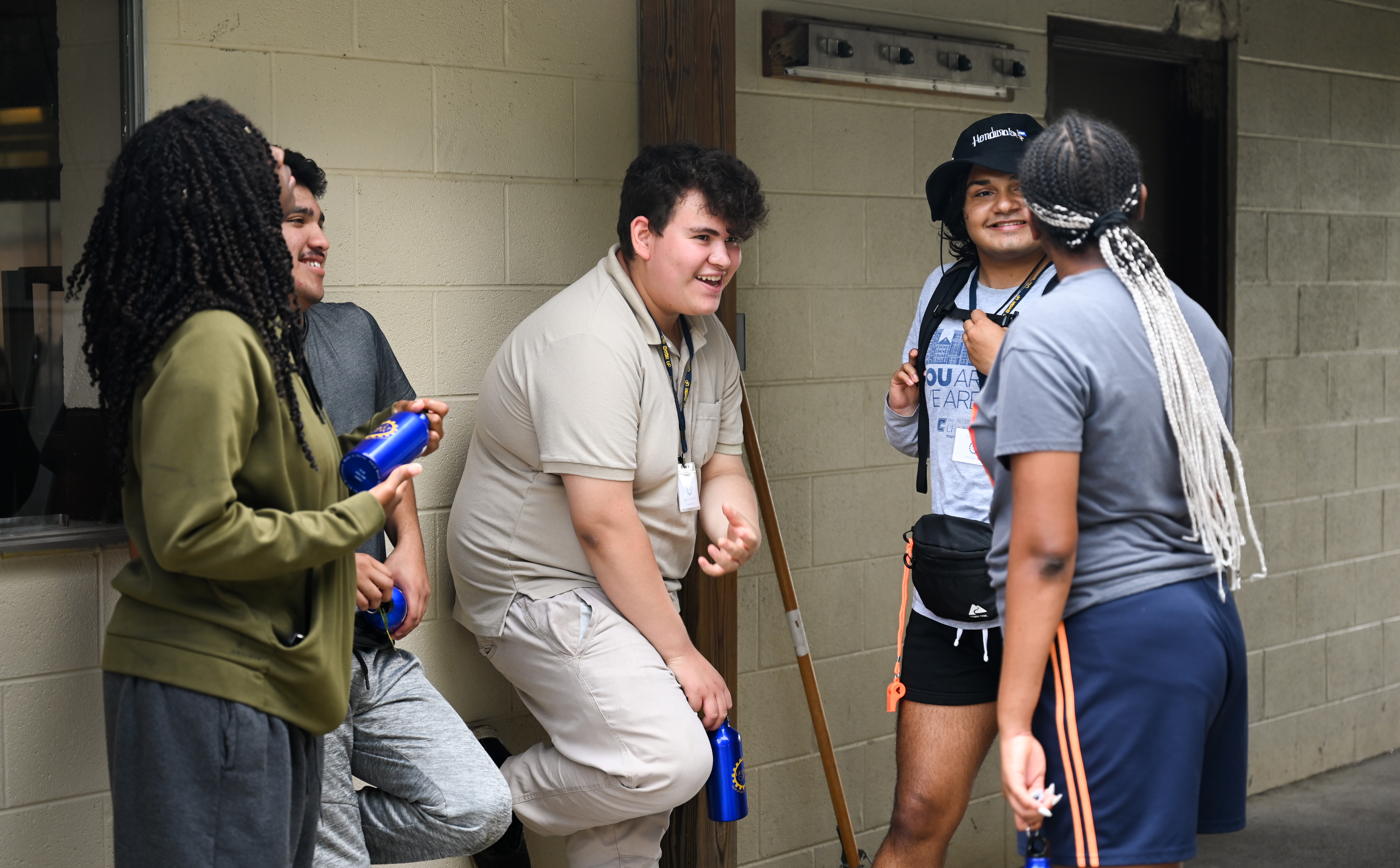Four people in a group laughing and conversing