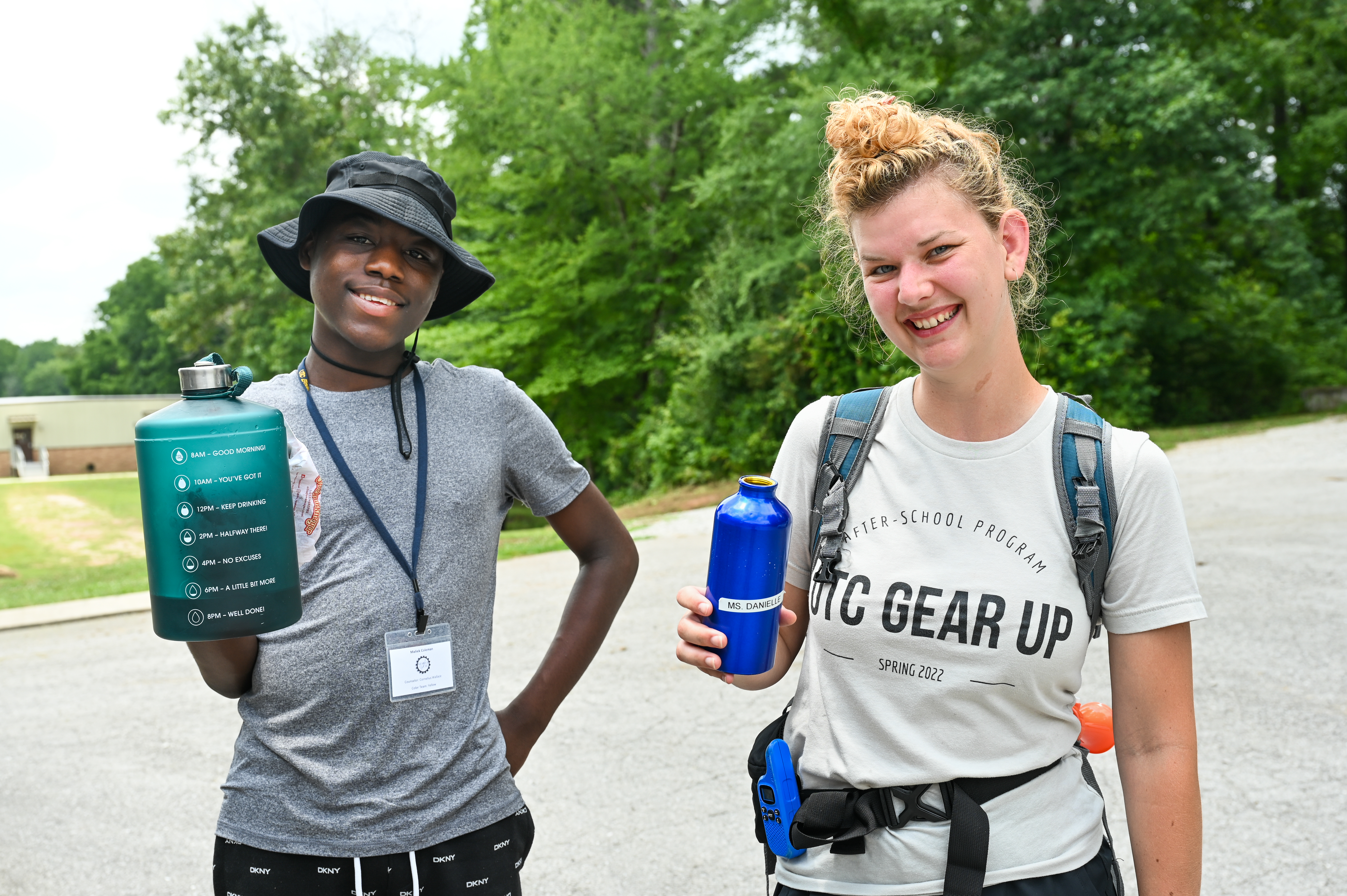 Staff and student showing off their water bottles at Summer Camp