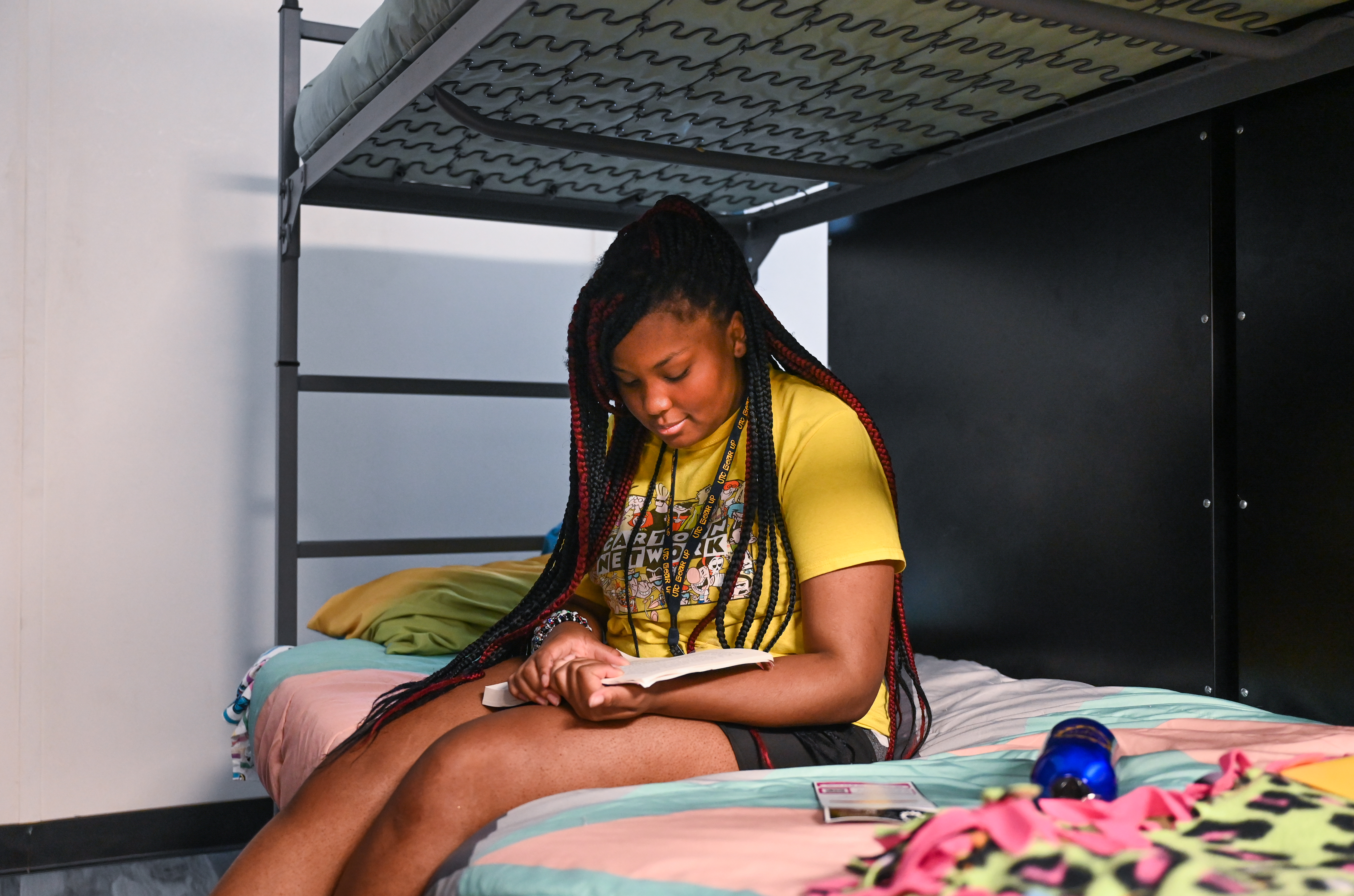 A student reading on bed at Summer Camp