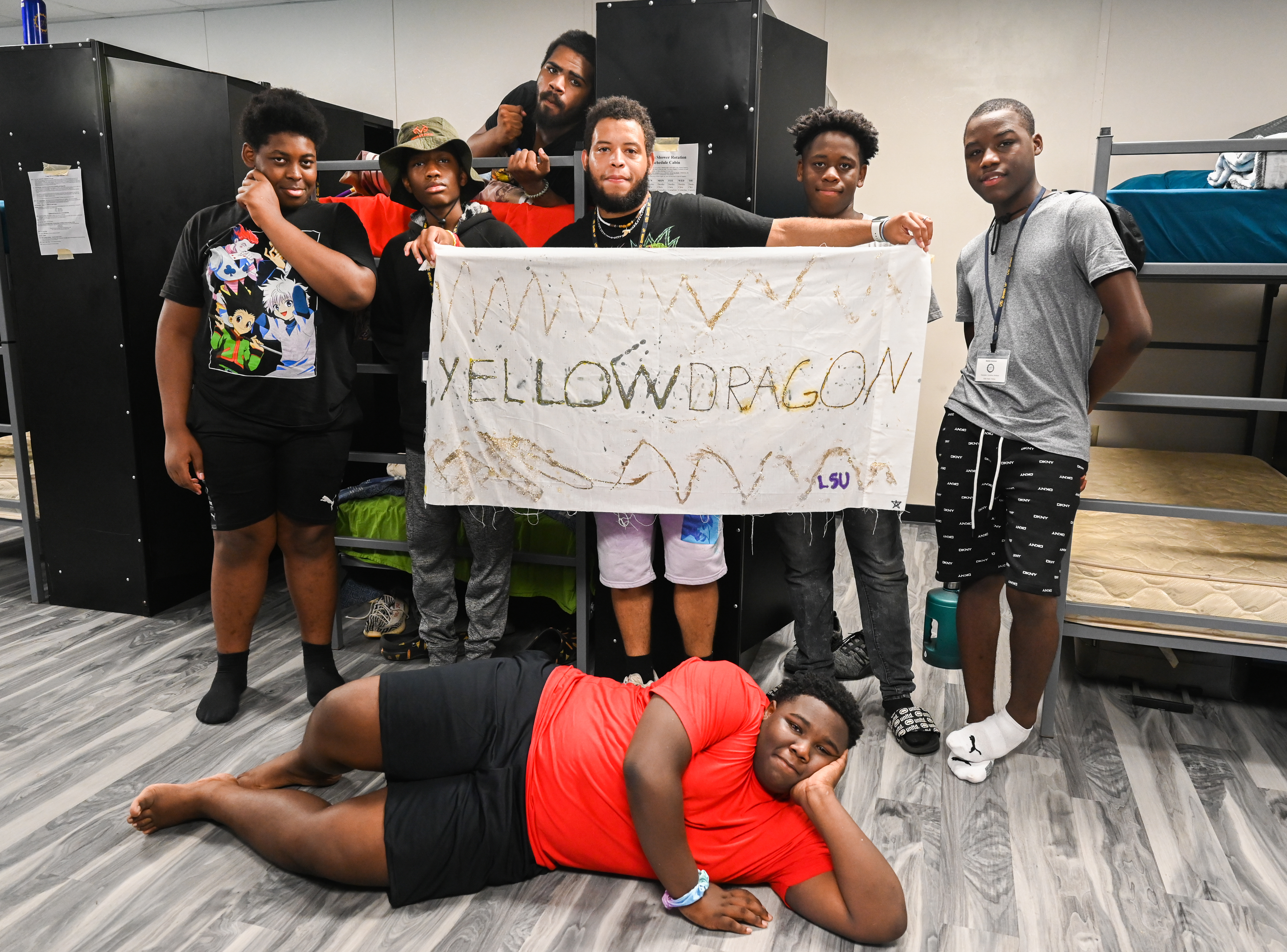 A group posing for picture whiling holding poster
