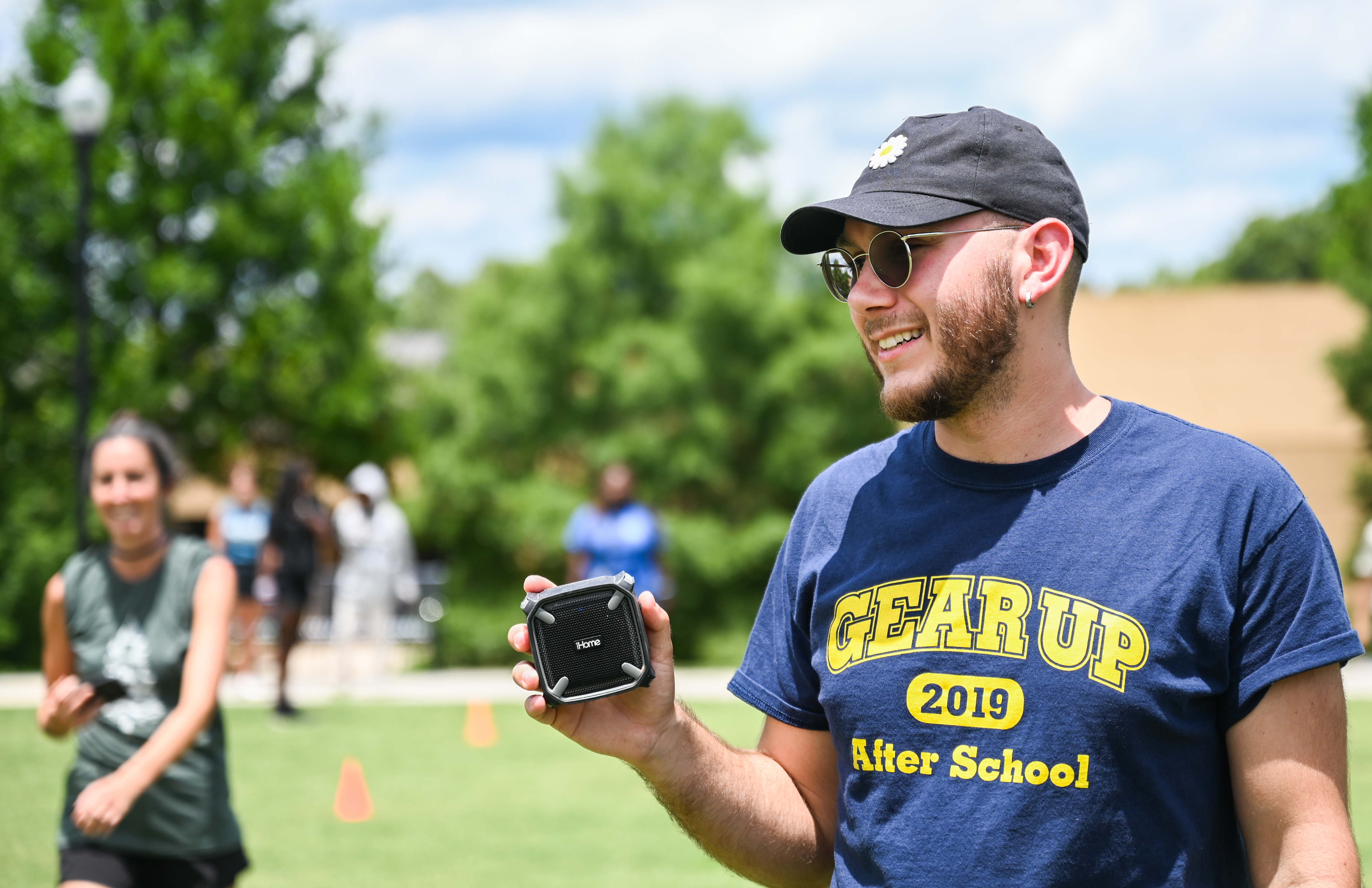 A man smiling whiling holding object