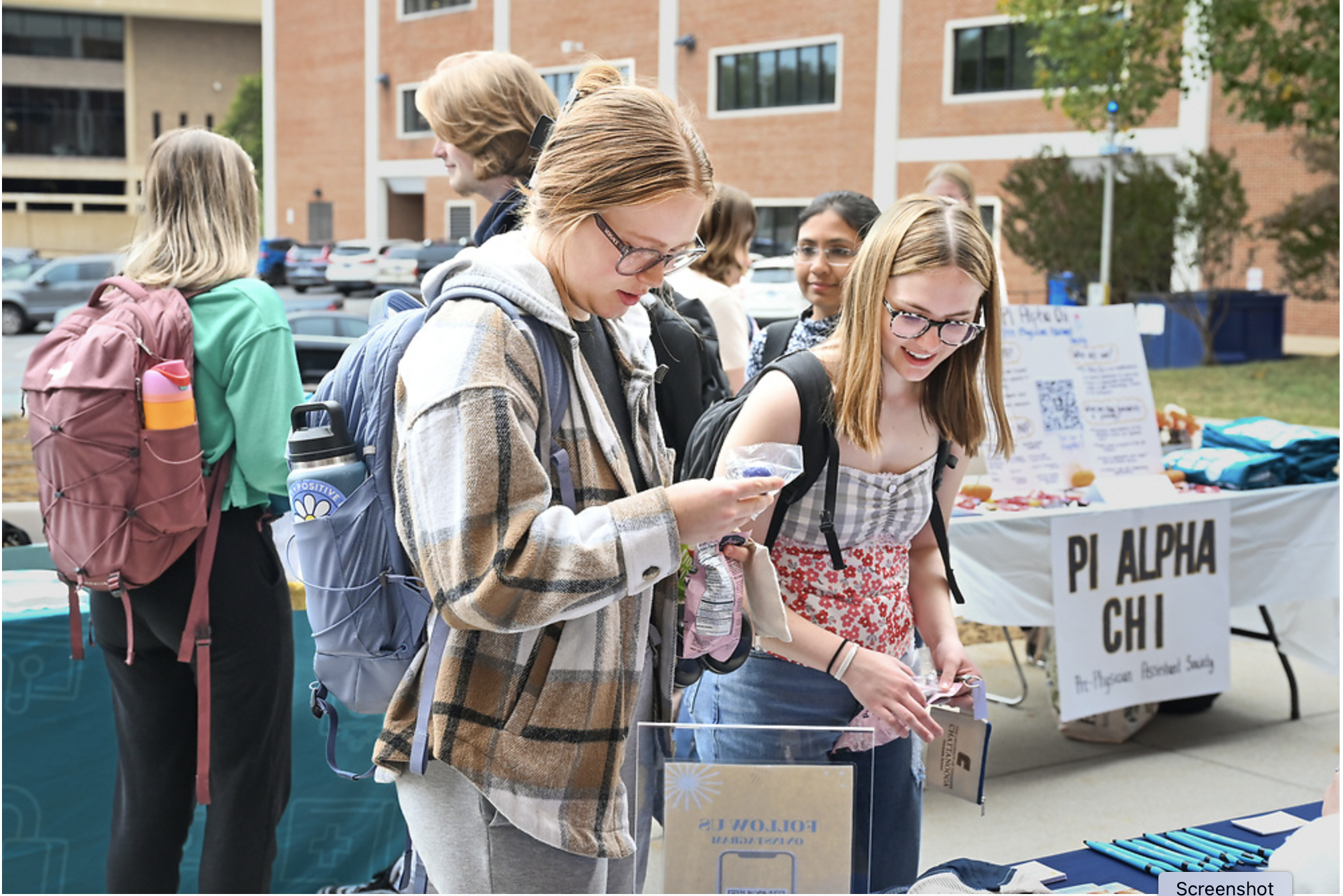BGE Fall Festival 2023 1 Students looking at festival table
