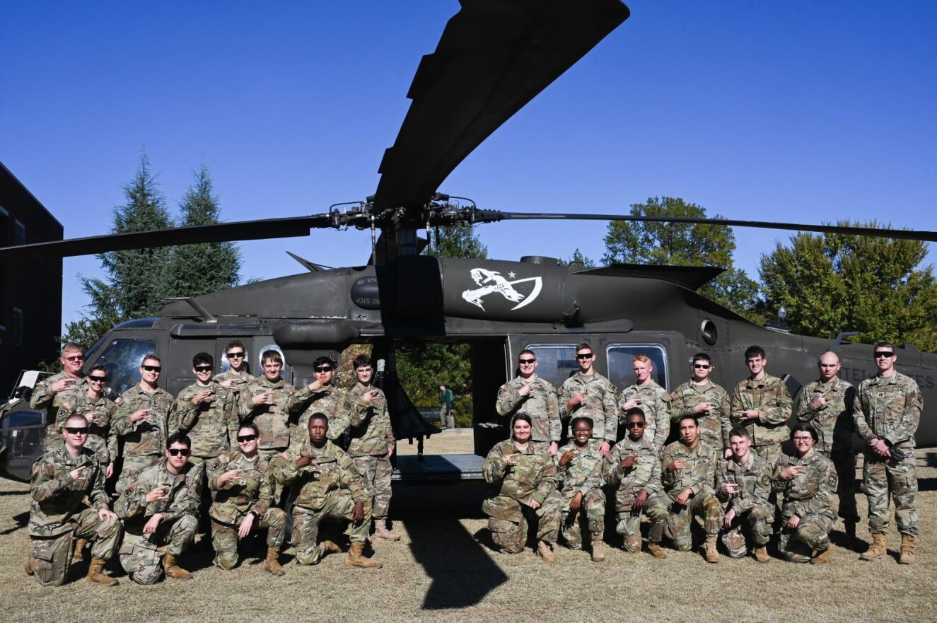cadets posed in front of helicopter
