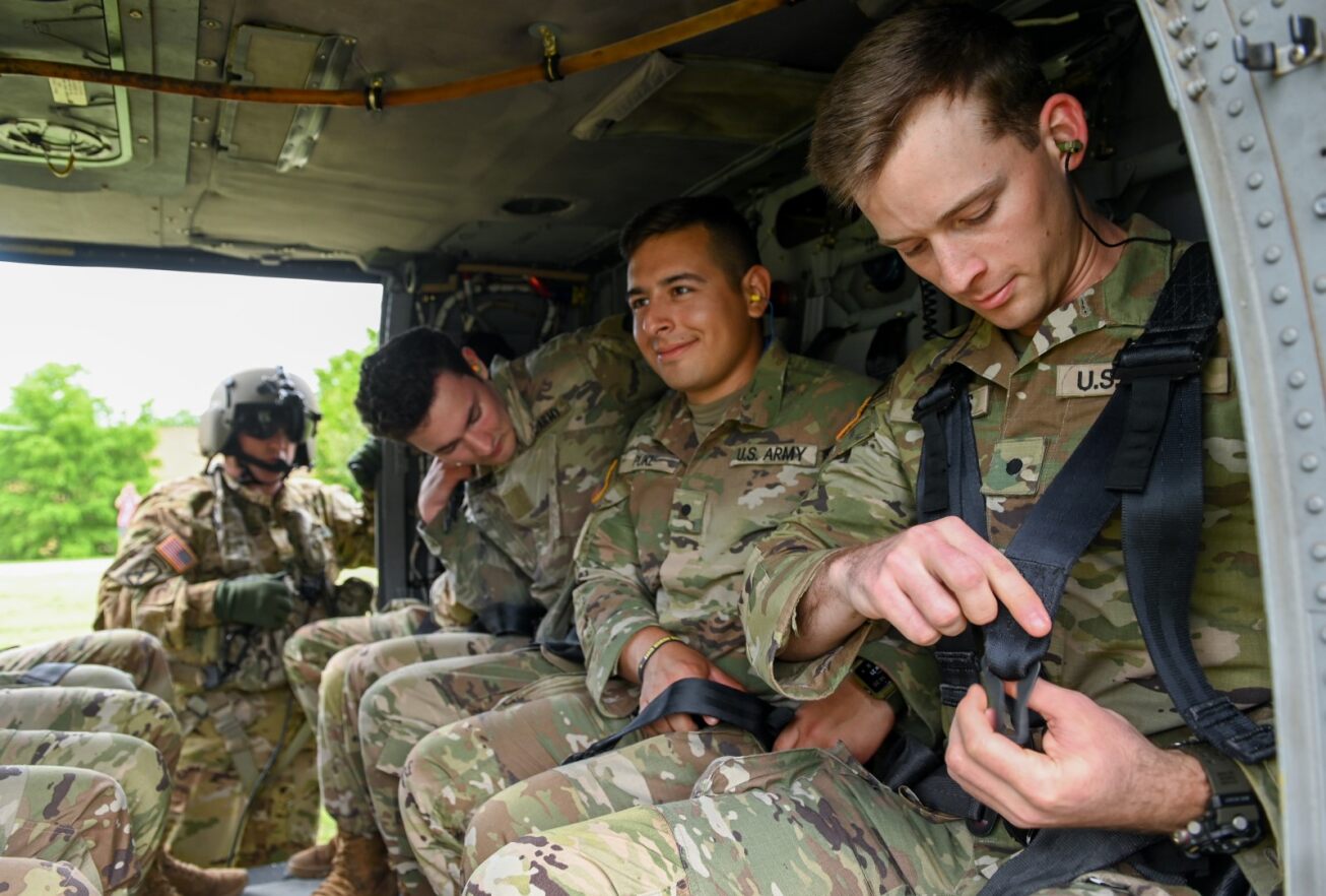 cadets buckling seatbelts in helicopter
