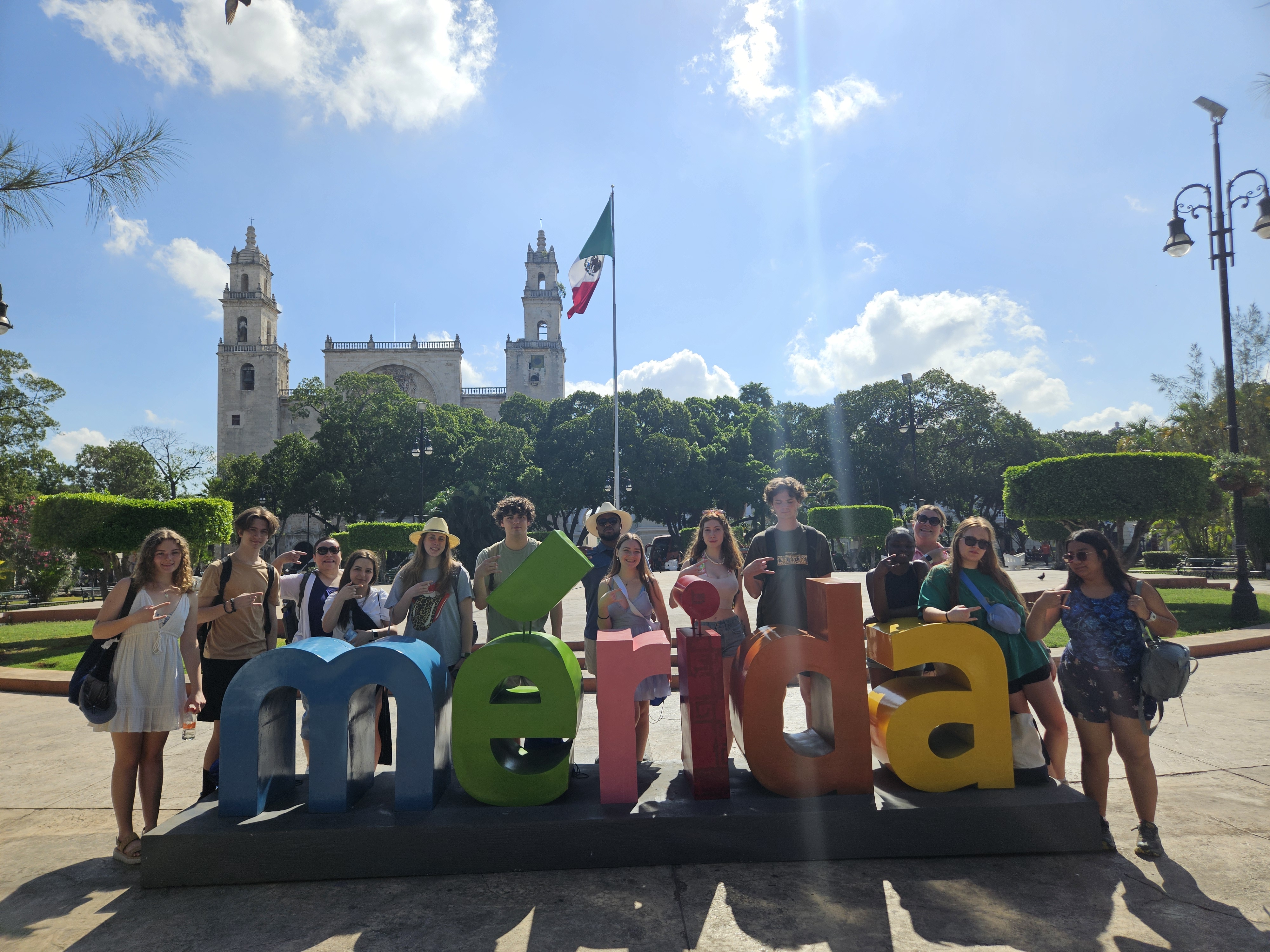 A&SRC Explorers tour Merida's Historic Center Students pose in front of the Merida sign in the city's Historic Center