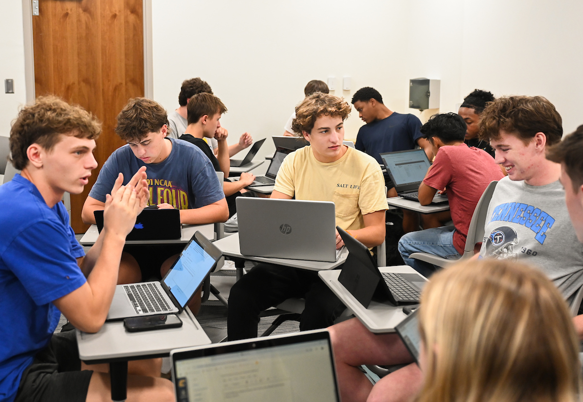 Mindset class at UTC Students with laptops out in class formed in a circle