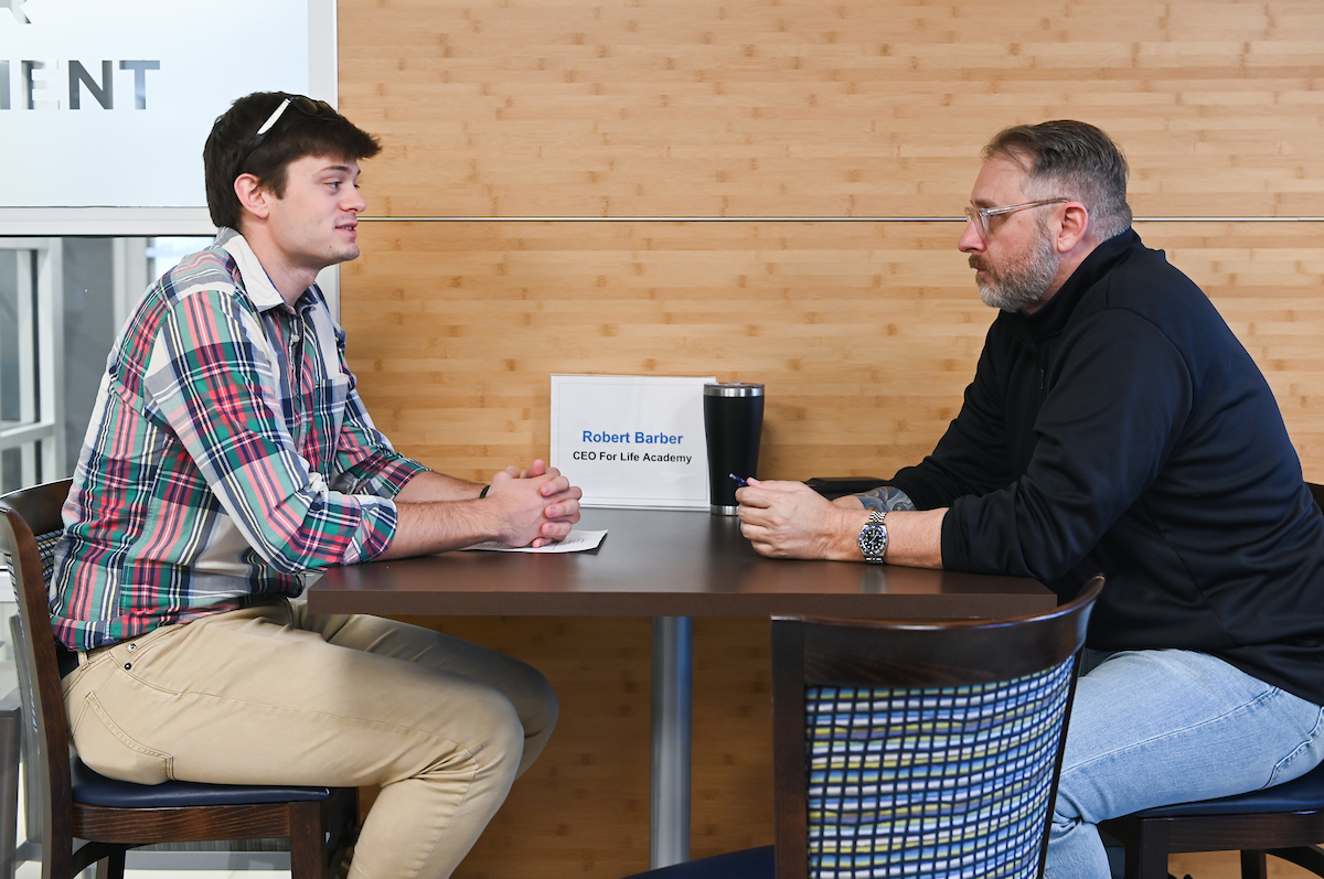 Student doing resume week Student interviewing on campus
