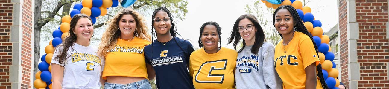 UTC Readmitted students utc students standing under an "I love UTC" ballon banner