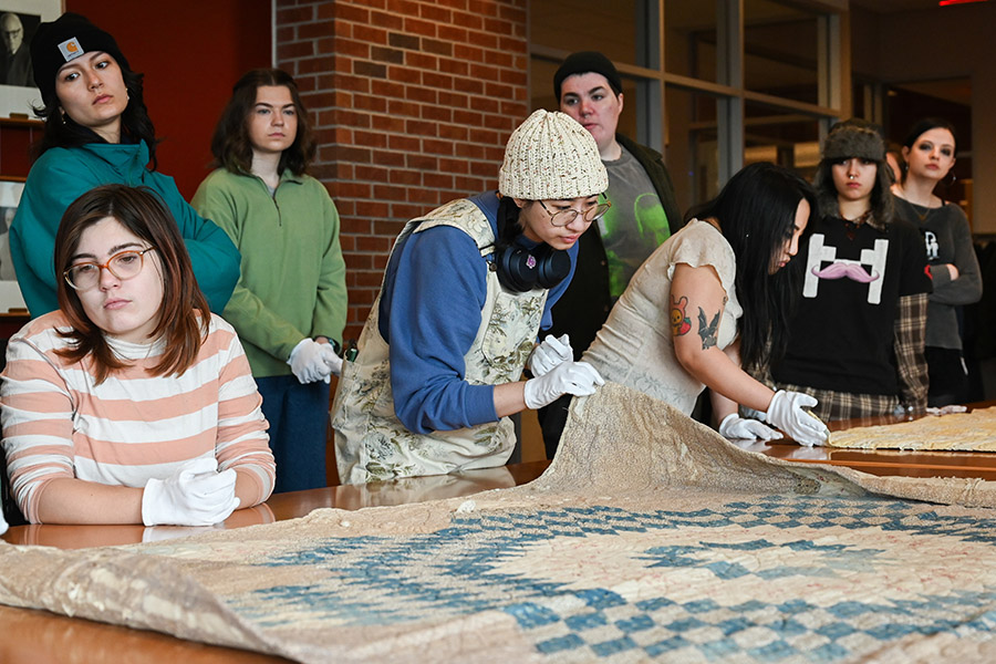 Students in Professor Pushaw’s ART 3999: History of Craft examining quilts from Special Collections in Spring 2024. Students in Professor Pushaw’s ART 3999: History of Craft examining quilts from Special Collections in Spring 2024.