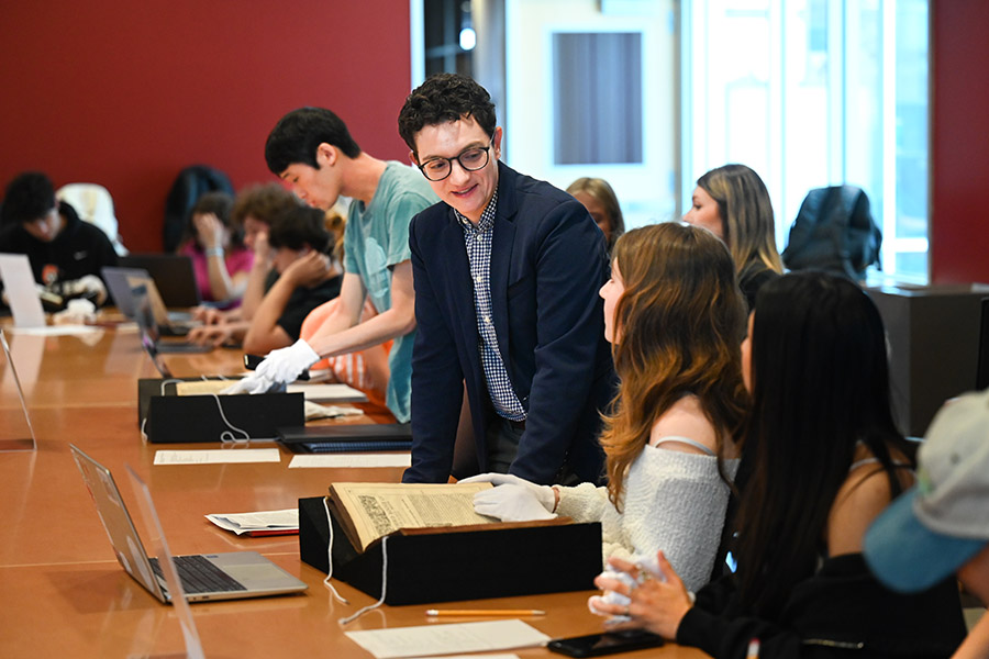 Professor Taylor and students in HIST 2220: Europe and the World examine rare books from Special Collections in Fall 2023. Professor Taylor and students in HIST 2220: Europe and the World examine rare books from Special Collections in Fall 2023.