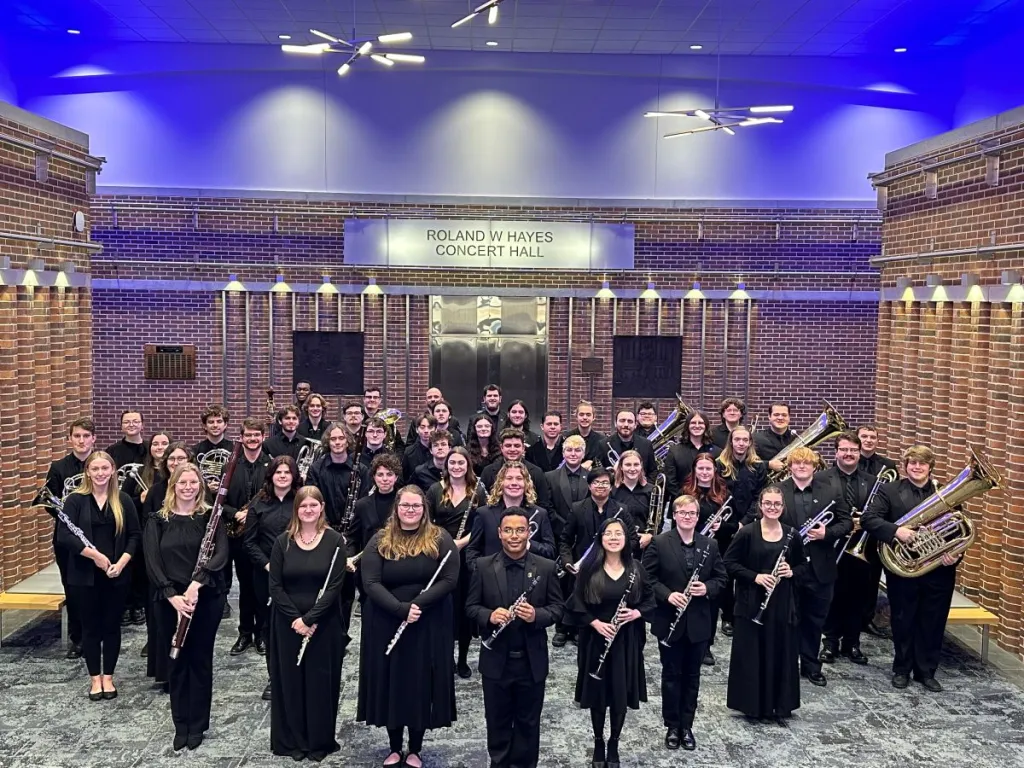 UTC Wind Ensemble with students holding instruments