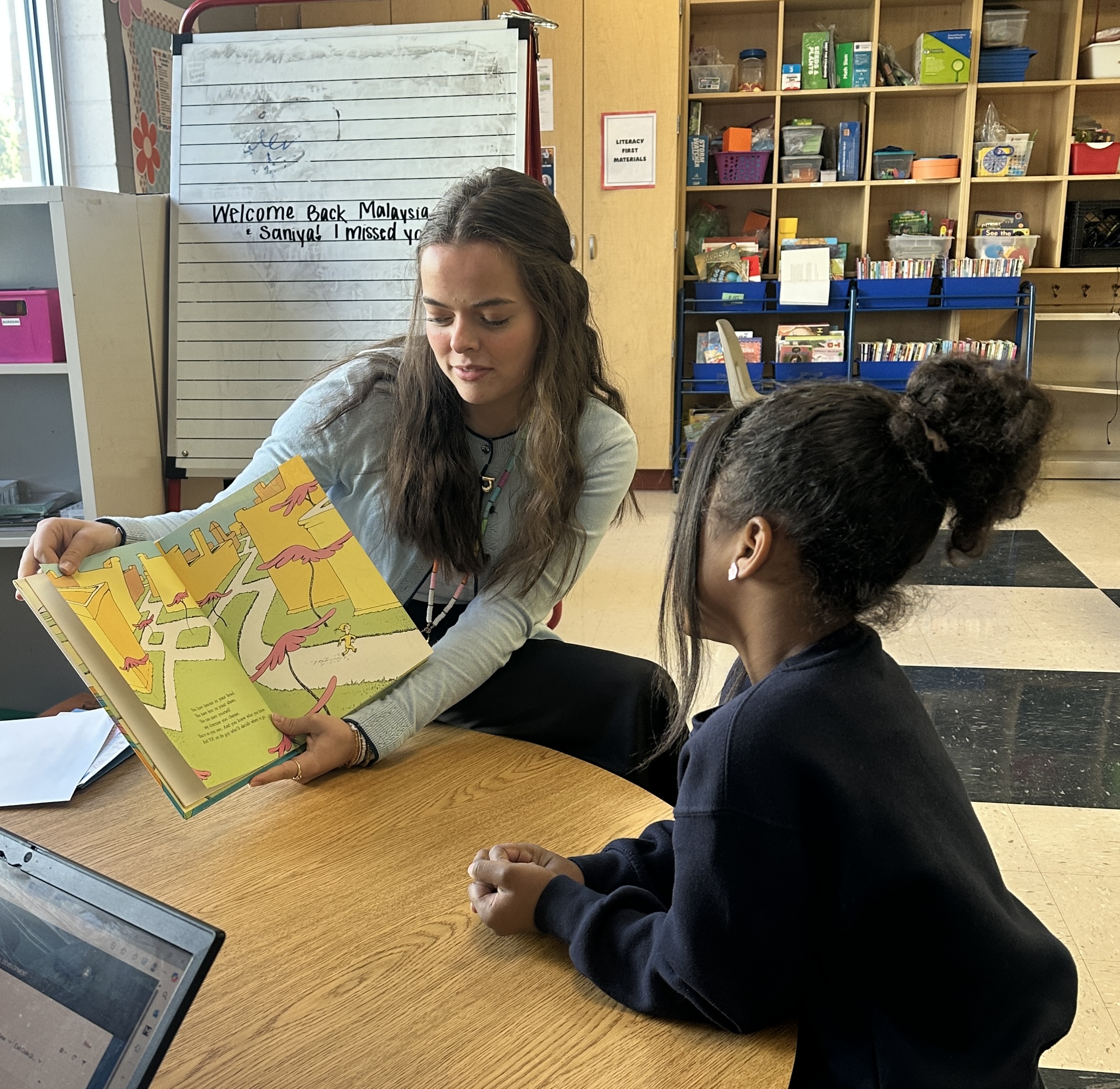 Literacy First tutor reading with Brown Academy student