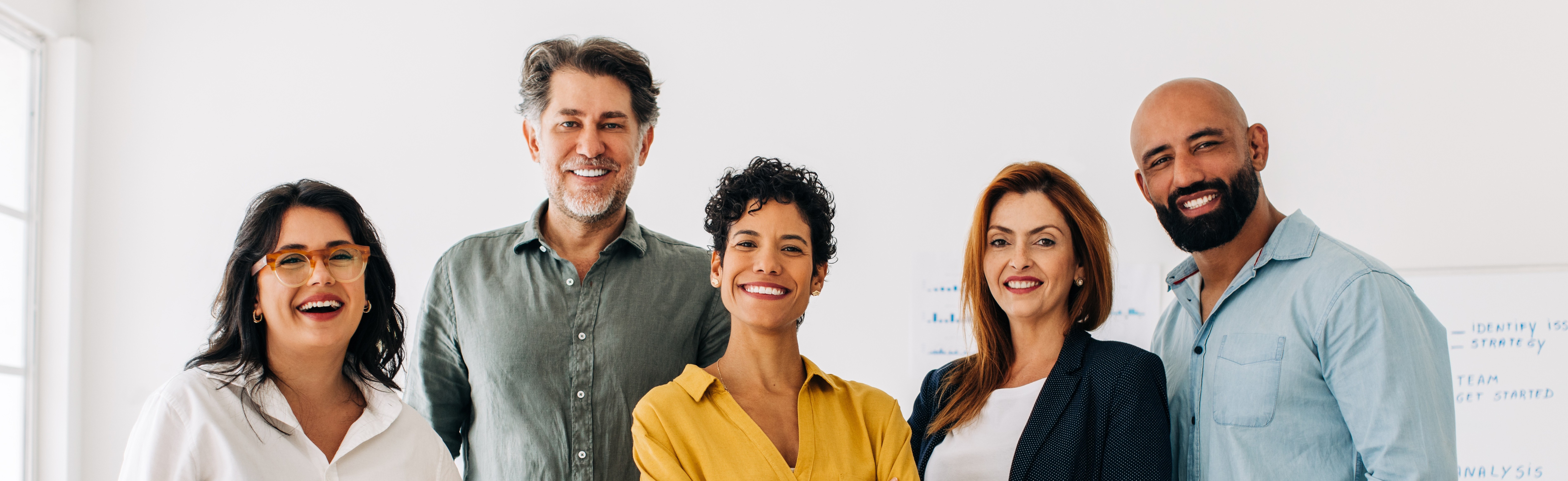 Office group photo with five professionals smiling, human resources staff