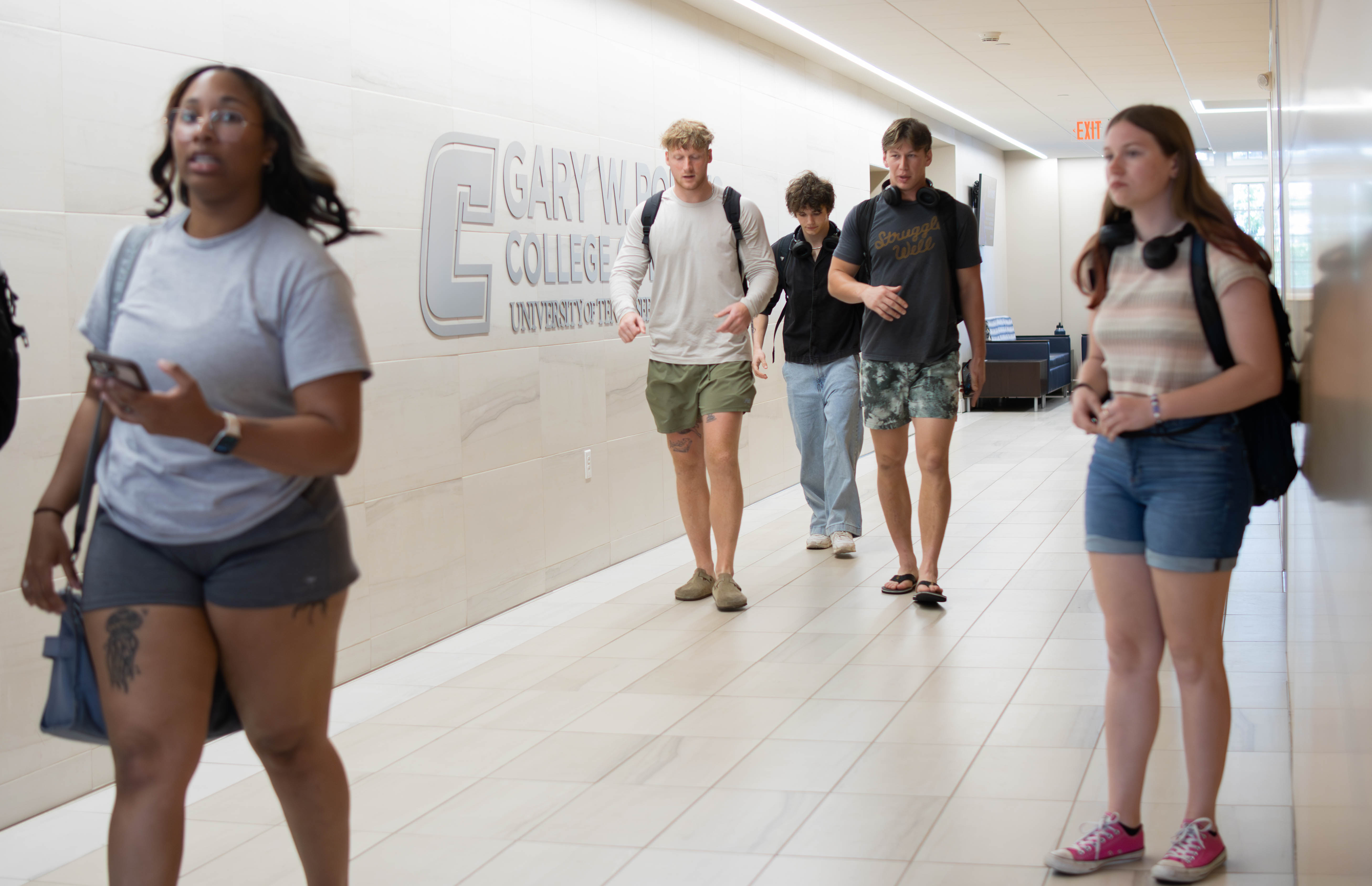 Students walk through the halls of Fletcher Hall between classes. 