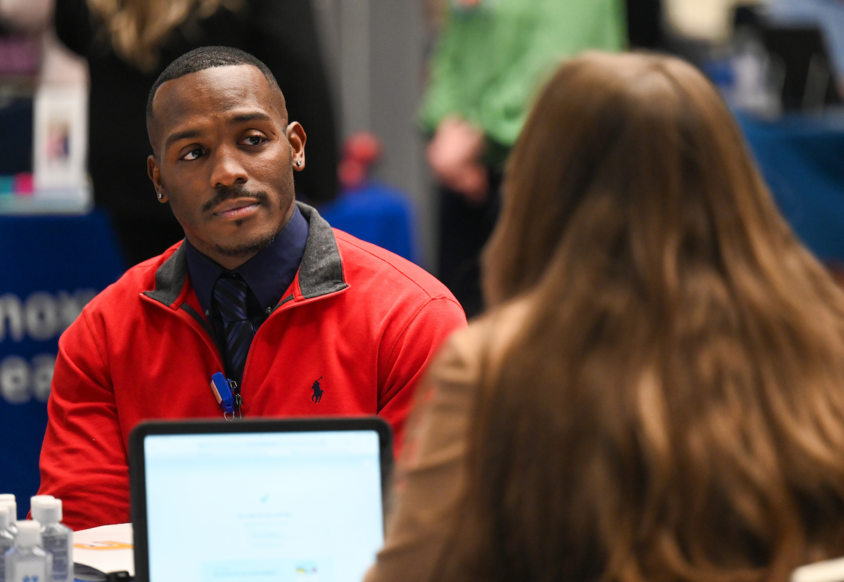 A UTC student talking to a perspective employer at the social work career fair