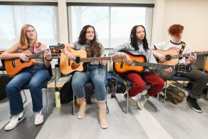 Photo of Music Therapy students playing guitar