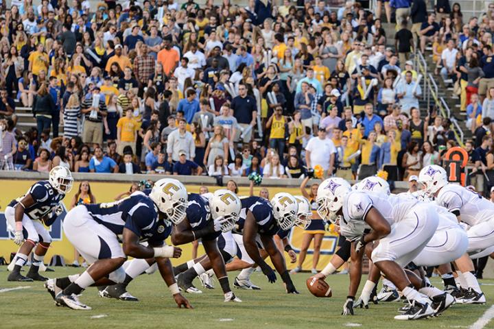 UTC football team stands in starting formation