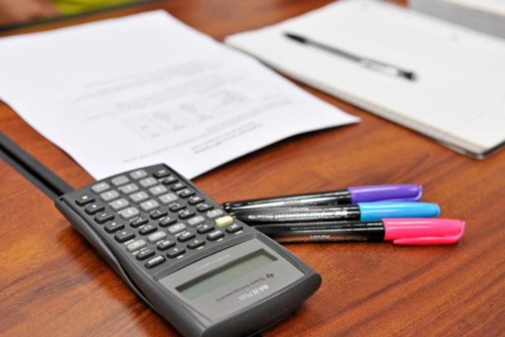 Desk of calculator and pens