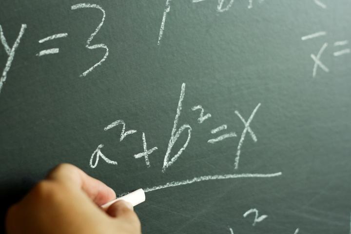 Green chalkboard with algebraic equations
