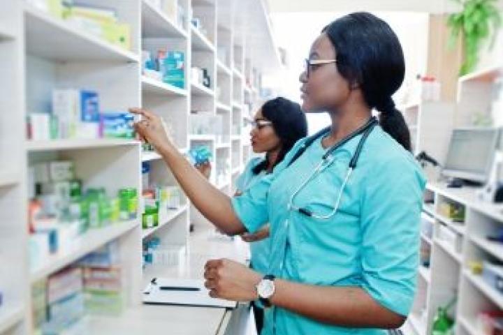 Women in scrubs looking for medicine