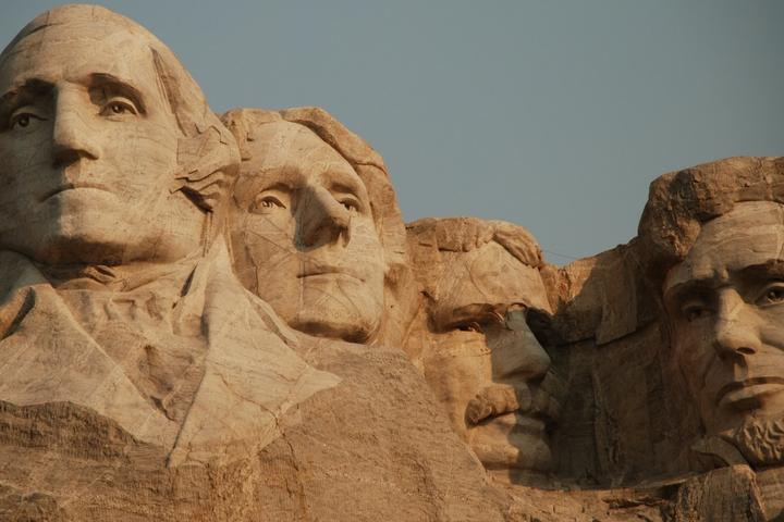 mount rushmore, all four presidential heads carved into the side of the mountain