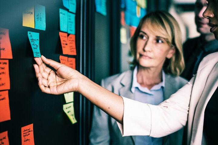 Woman looking at a sticky note with deadly intent