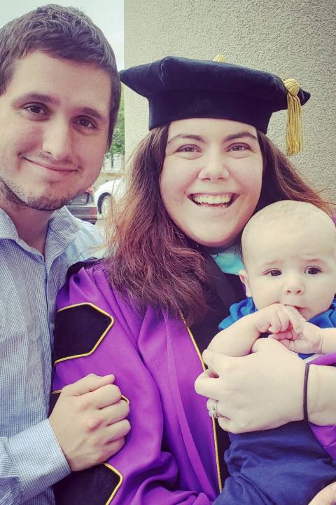 Allison Plattsmier Allison Plattsmier in graduation attire beside partner with baby in hand