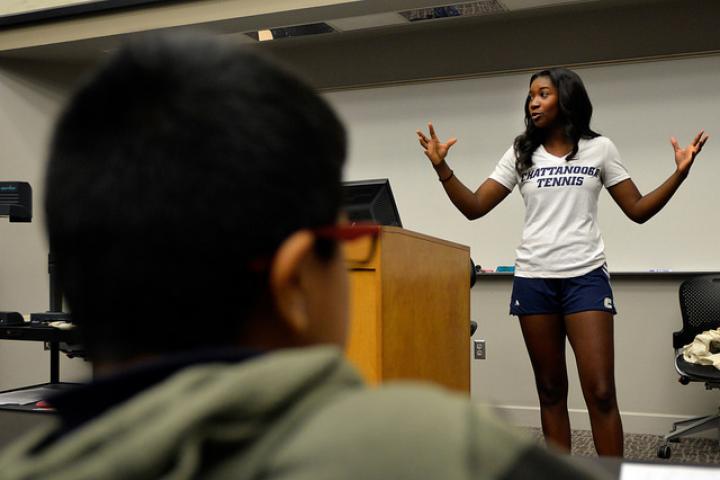 Student standing in front of audience presenting
