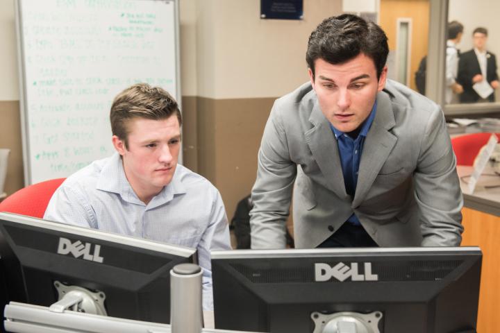 Two students at computers solving a problem