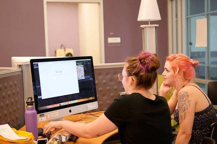 students working at studio computer
