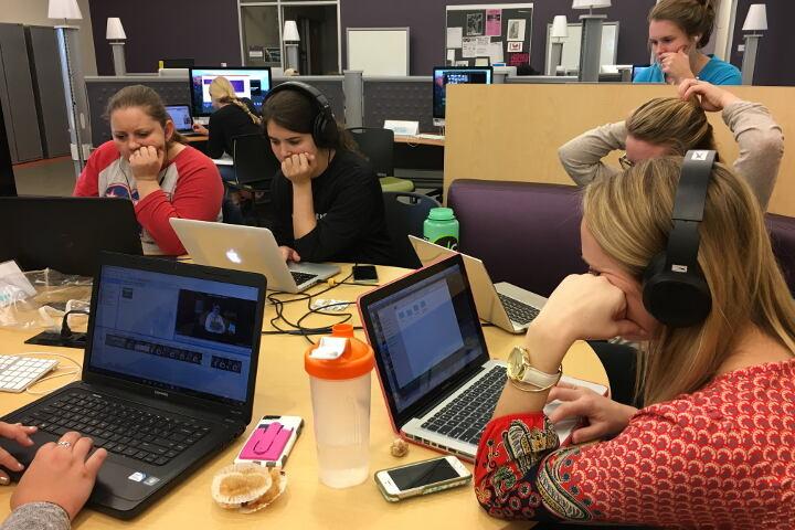 students around a media table