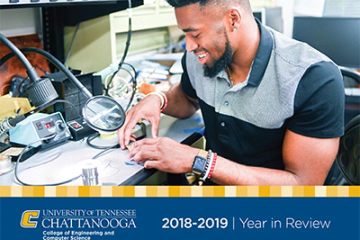 Cover of 2018-19 Year in Review with male student working on a project