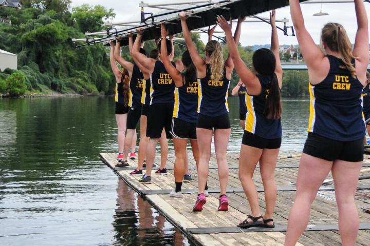 UTC Rowing Crew Preparing to place a boat into the Tennessee River from the UTC Rowing Barge