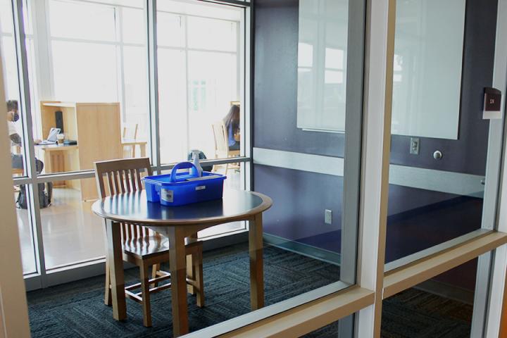 small study room with one chair and cleaning equipment