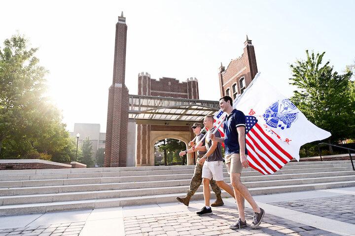 students walking with flags on chamberlain field