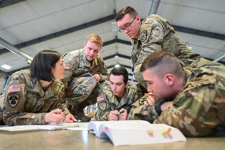 cadets at table looking at document