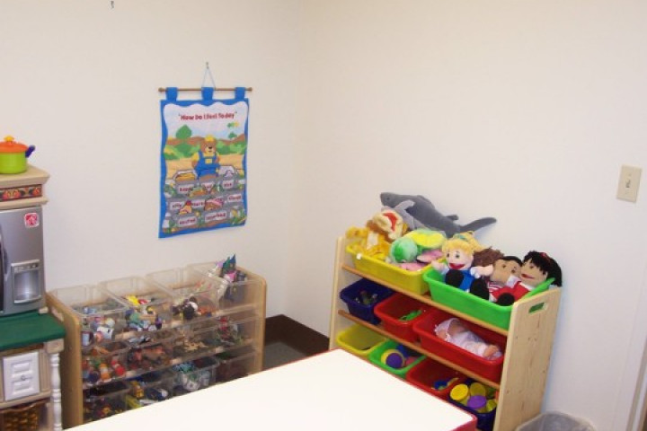 Image of playroom for play therapy with tubs holding various toys