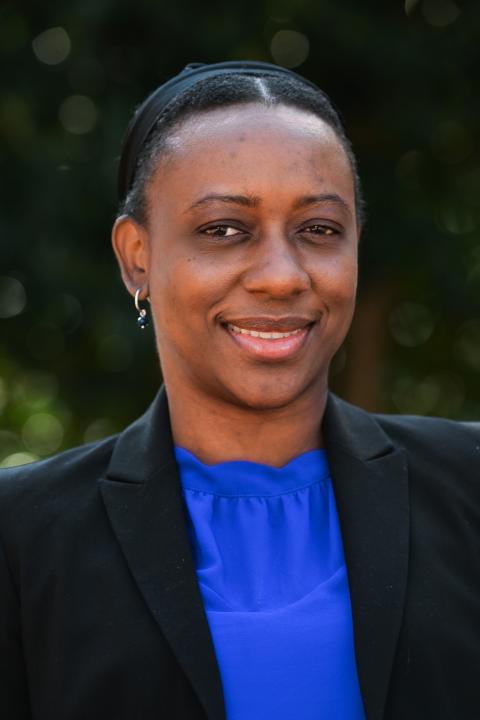 Profile photo of Dr. Leanora Brown in a black jacket and blue shirt