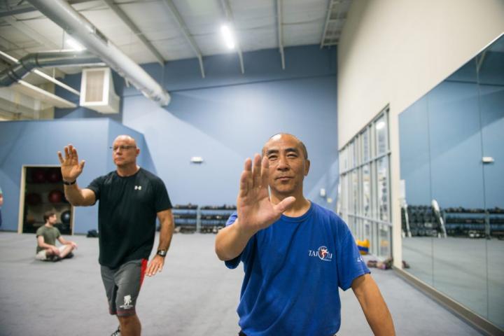 Two men performing tai chi