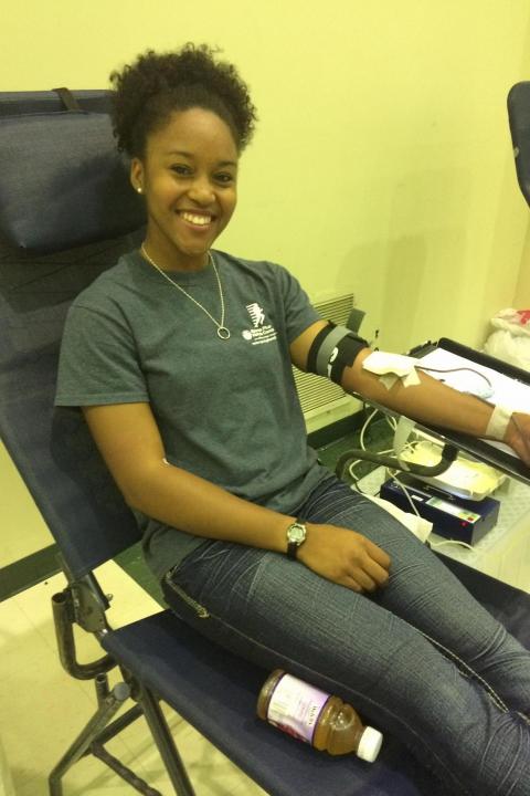 Woman smiling whilst giving blood