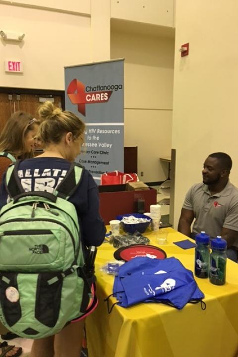 People gathered around Chattanooga cares table