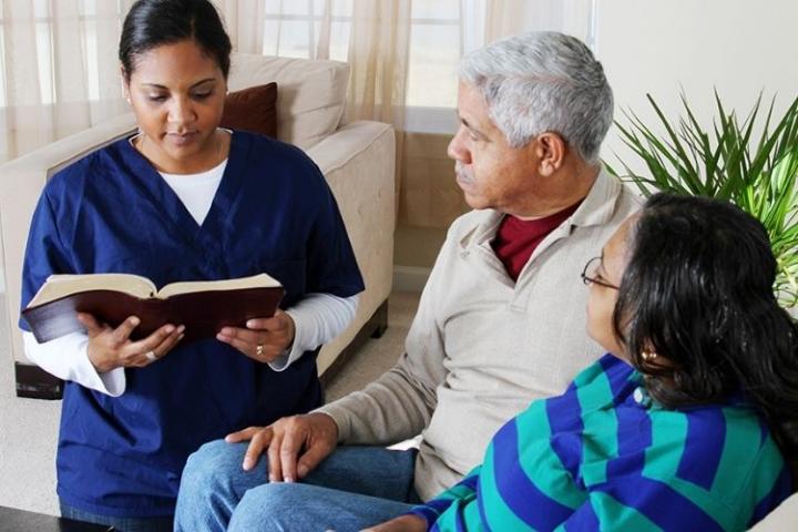 A medical interpret talking to a couple