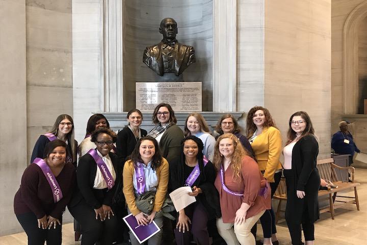 Group picture in front of bronze bust