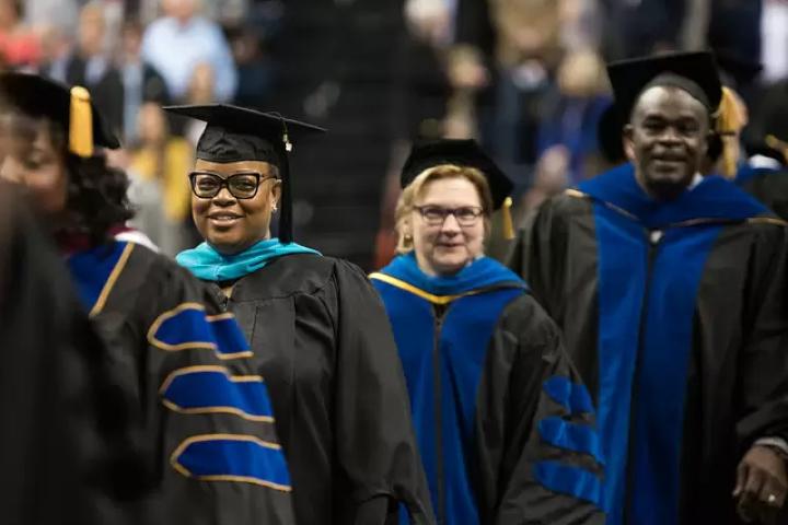 Students walking the aisle at graduation