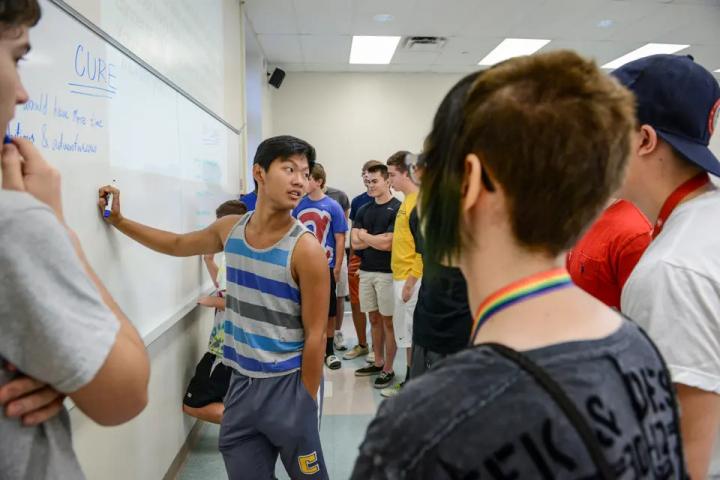 students in front of the board